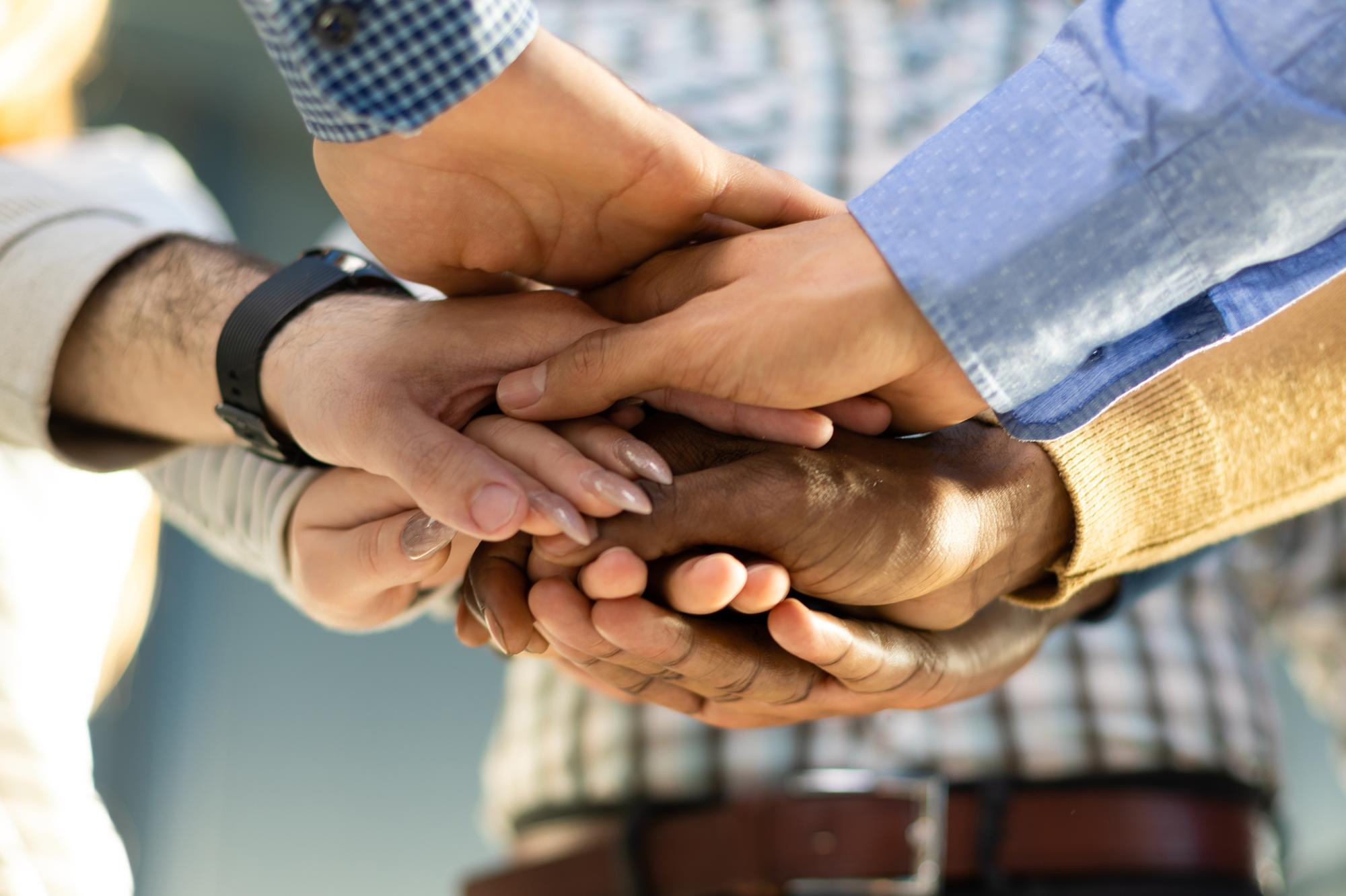 Two people holding hands in support